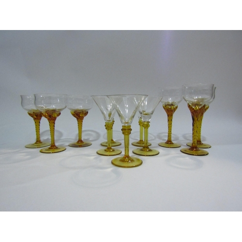 4404 - A set of six wine glasses with amber twisted stems and five cocktail glasses with amber stems