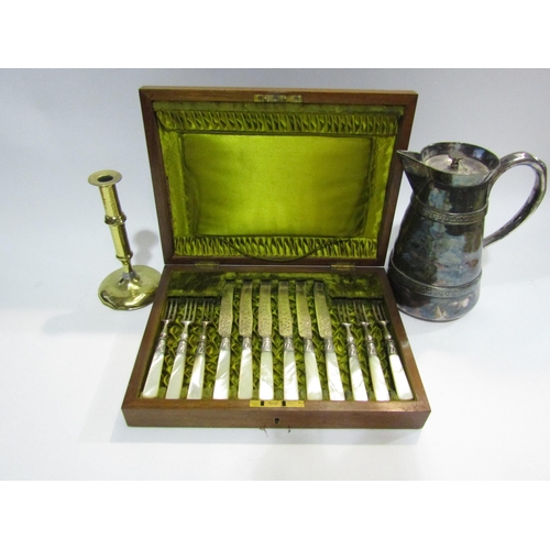 4419 - A mother-of-pearl handled set of six fruit knives and forks together with a brass candlestick and a ... 