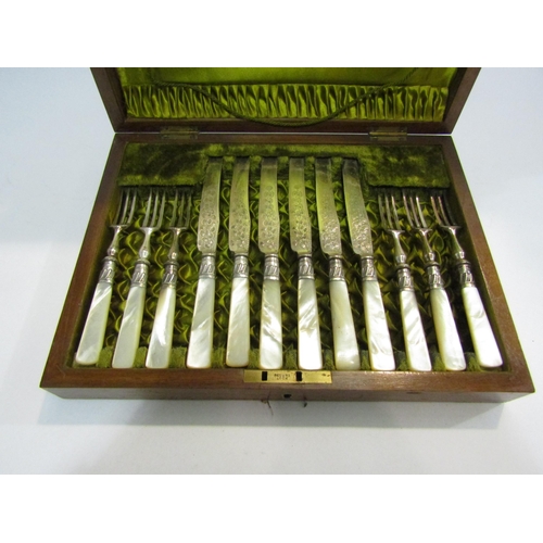 4419 - A mother-of-pearl handled set of six fruit knives and forks together with a brass candlestick and a ... 