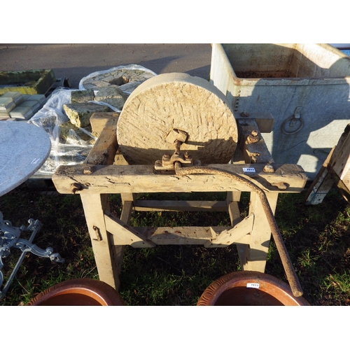 7032 - A grinding stone in wooden frame