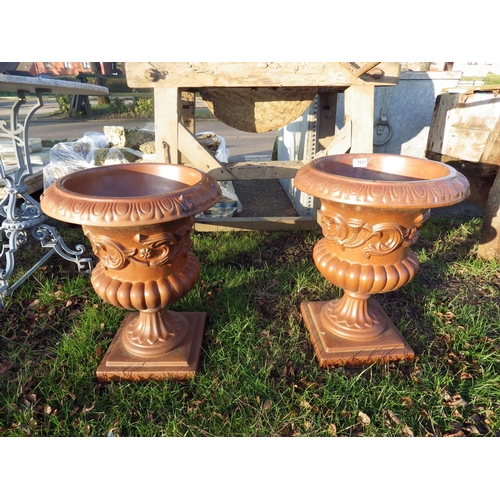 7033 - A pair of glazed stoneware semi-gadrooned urns, 20