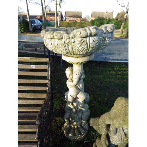 7054 - A composition garden planter standing on a three cherub base, 42