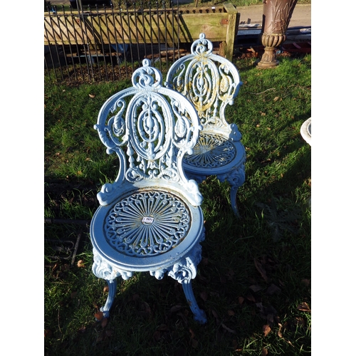 7071 - A pair of decorative cast iron garden chairs  (R)  £100