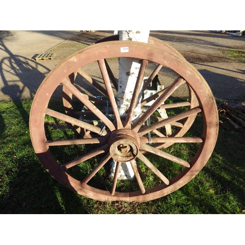 7079 - A pair of wooden, iron rimmed cart wheels, 49