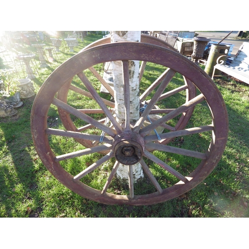 7079 - A pair of wooden, iron rimmed cart wheels, 49