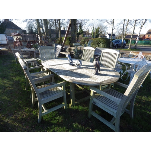 7109 - A Lister hardwood extending garden table and six matching armchairs, table is 93