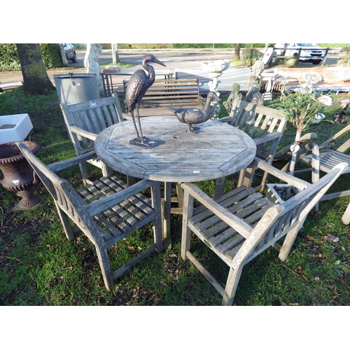 7114 - An Alexander Rose circular hardwood garden table and four matching armchairs, 4ft diameter