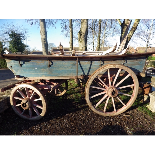 7121 - A rustic wooden four wheel hay cart with Joslins Limited, Colchester plaque