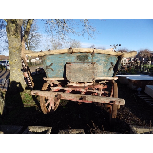 7121 - A rustic wooden four wheel hay cart with Joslins Limited, Colchester plaque