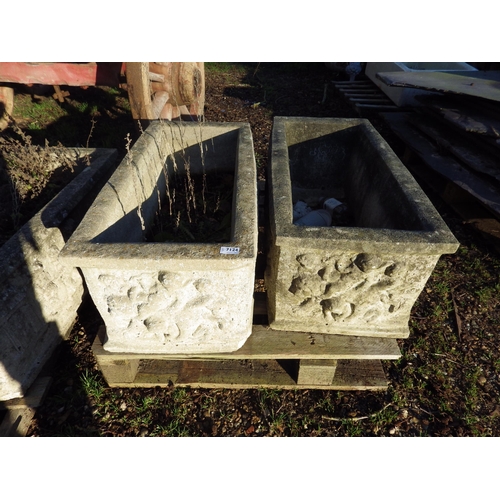 7124 - A pair of reconstituted trough form planters, cherub relief detail, 35