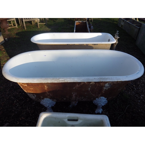 7129 - An early 20th Century French double ended roll top bath on foliate feet