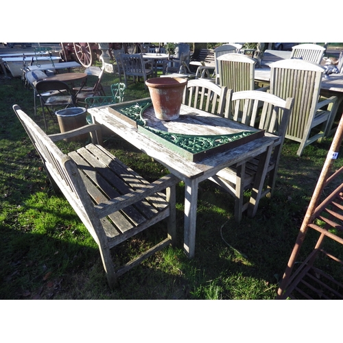 7141 - A hardwood garden table, bench and two chairs