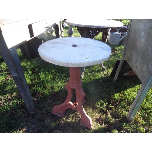 7168 - A cast iron tripod based table with round marble top  (R)  £40