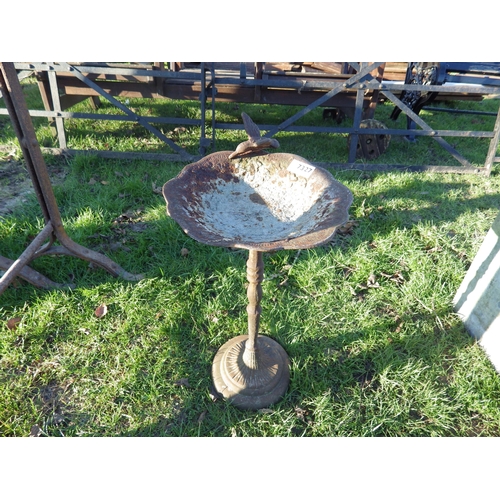 7327 - A cast iron bird bath surmounted by bird, 19