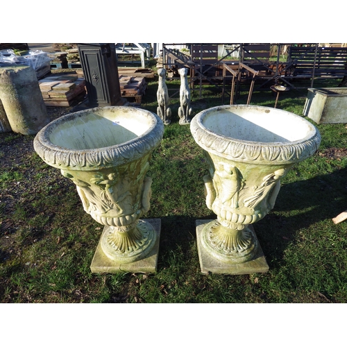 7340 - A pair of composition twin handle urns depicting maidens, 33