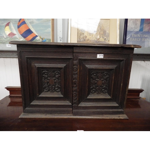 2115 - An Edwardian oak cabinet with two interior drawers