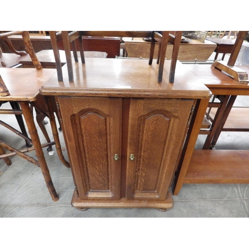 2128 - A Dutch oak two door cupboard with pull out shelves