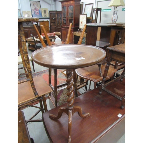 2168 - A mahogany circular dished top wine table on a barley twist column and tripod base