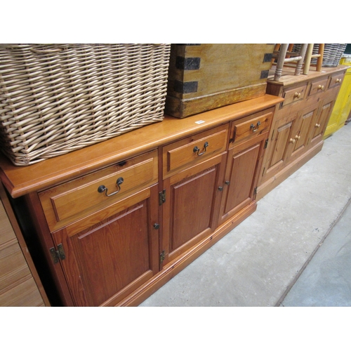 2223 - A pine three drawer, three door sideboard, with brass handles