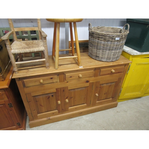 2228 - A pine three drawer, three door console unit