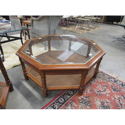 2330 - A modern octagonal coffee table with glass top and cane undertier, 37cm tall x 96cm across  (E) £10-... 