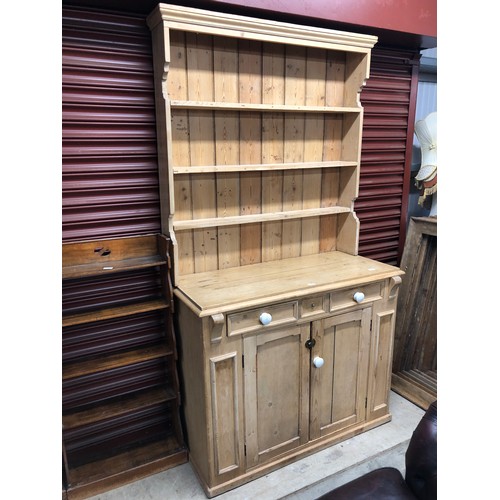 2355 - A country pine full height dresser, the plate rack top over a two drawer and two door cupboard to a ... 