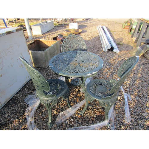 3255 - A cast alloy table with three chairs