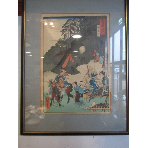 1017 - A Japanese woodblock print of a travelling salesman. Framed and glazed. 32.5cm x 22cm image size