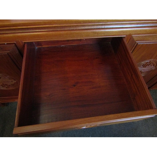 1022 - A Chinese elm sideboard with four central drawers and two 