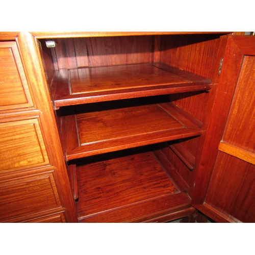 1022 - A Chinese elm sideboard with four central drawers and two 