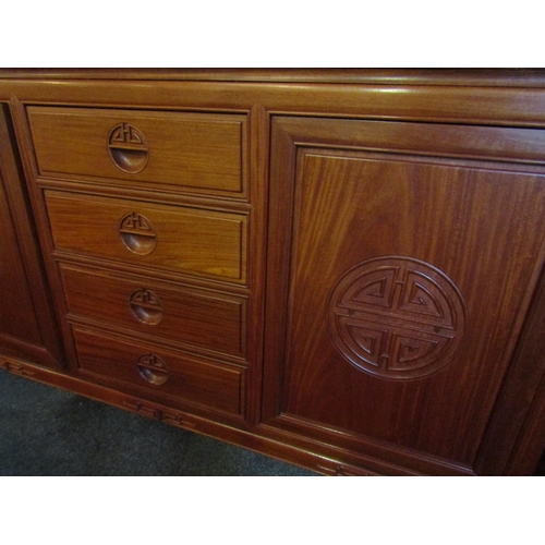 1022 - A Chinese elm sideboard with four central drawers and two 