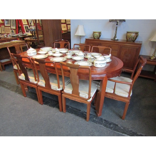 1025 - A Chinese elm extending circular top dining table with two extra leaves, 79cm tall x 204cm long x 11... 