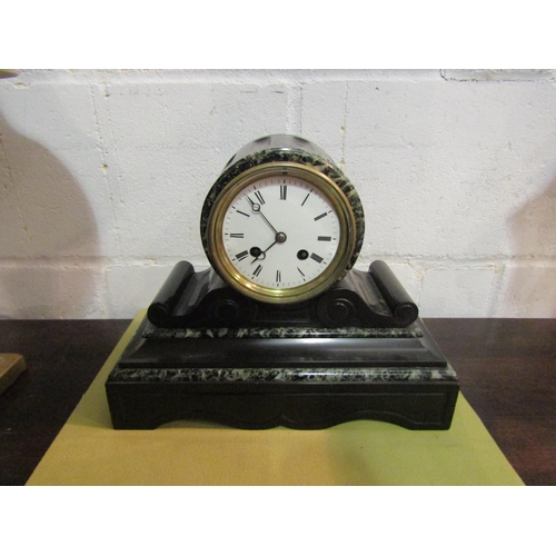 1039 - A slate and marble mantel clock, Roman numerated, 24cm tall