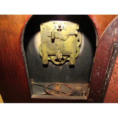 1052 - A 1940's mahogany mantel clock with key and pendulum