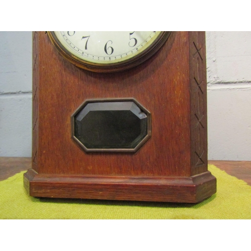 1519 - An oak cased mantel clock striking on a bell, bell 16cm diameter