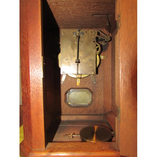 1519 - An oak cased mantel clock striking on a bell, bell 16cm diameter