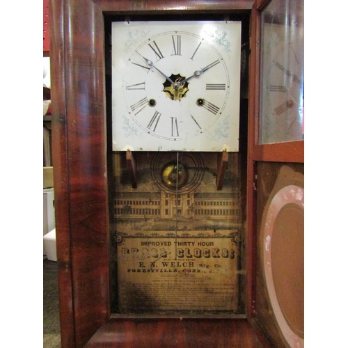 1080 - An American wall clock with Roman numerals and glass panel depicting female, with pendulum and key