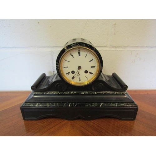 1101 - A French slate and marble mantel clock, Roman numerated dial, with key and pendulum, 23cm tall x 35c... 