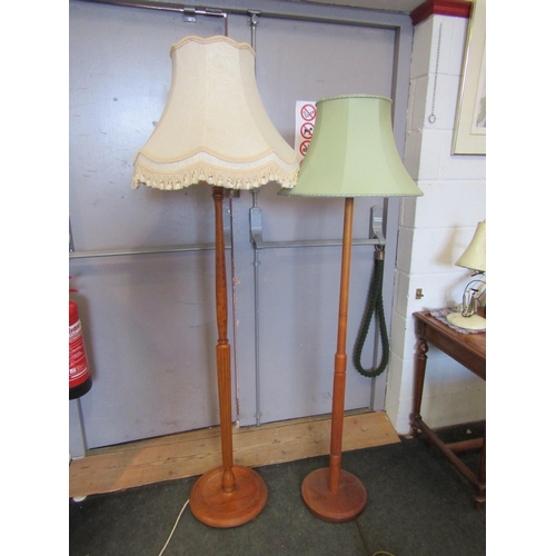 1109 - Two wooden standard lamps with shades