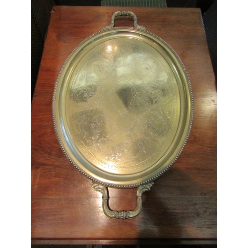 1114 - A plated twin handled tray with gadrooned rim, vacant cartouche, 76cm long