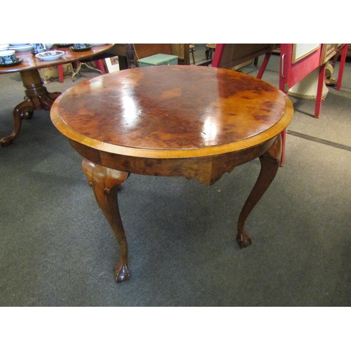 1148 - A 19th Century walnut breakfast table, quarter veneered top, shaped frieze, on ball and claw cabriol... 