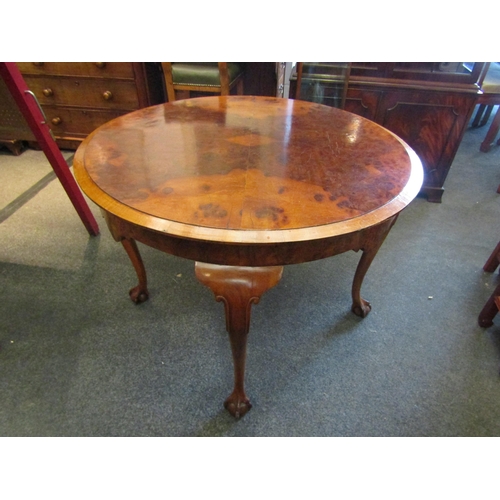 1148 - A 19th Century walnut breakfast table, quarter veneered top, shaped frieze, on ball and claw cabriol... 