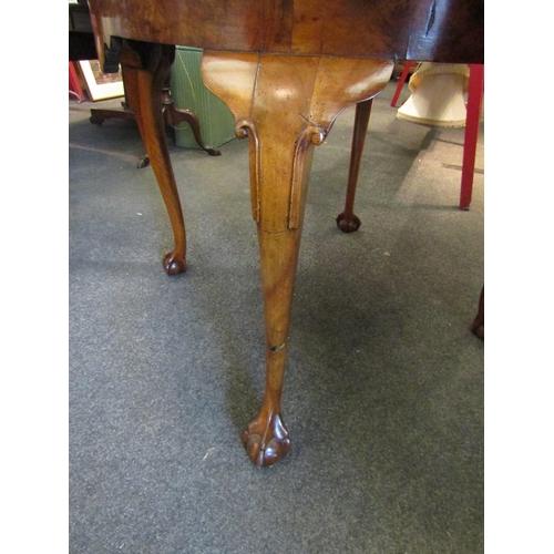 1148 - A 19th Century walnut breakfast table, quarter veneered top, shaped frieze, on ball and claw cabriol... 