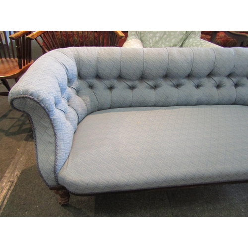 1179 - A Victorian walnut settee, buttoned pale blue upholstery, turned supports to castors. 158cm L x 67cm... 