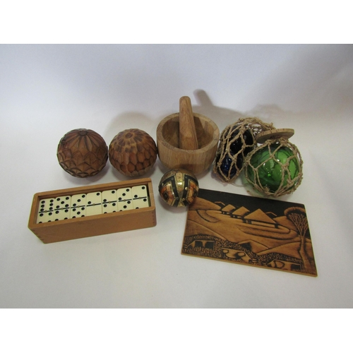 1208 - A wooden pestle and mortar, glass fishing floats, Domino set, burned wood picture etc.    (R) £10