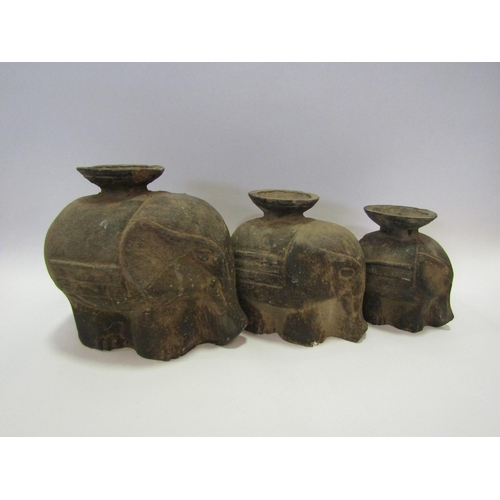 1215 - A graduated set of three terracotta tea light holders, largest 21cm, in the form of elephants