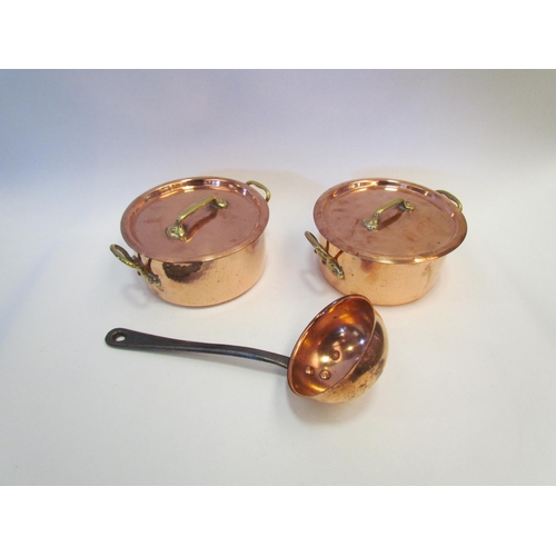 1283 - Two E Dehillerin copper lidded pans 16cm in diameter and an associated copper ladle