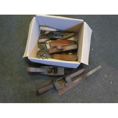 1287 - A box of bygone tools including wooden planes, brass hanging Salter scale, etc