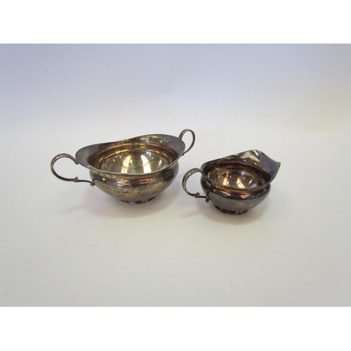 1357 - A silver twin handled sucrier and matching cream jug