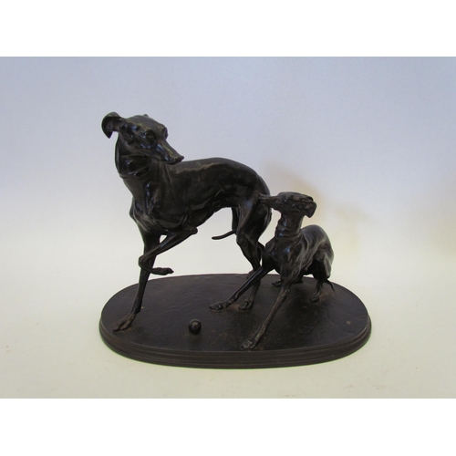 1361 - A cast iron figural group of two whippets with ball, 16cm tall x 20cm long